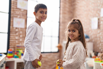 Brother and sister smiling confident playing bowling at kindergarten