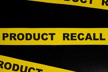Product recall alert, caution and warning concept. Yellow barricade tape with word in dark black background. - obrazy, fototapety, plakaty