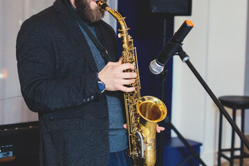 Concert view of saxophonist, a saxophone sax player with vocalist and musical band during jazz...