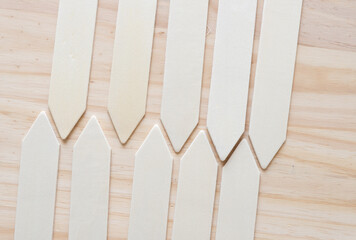 wooden gardening stick tags, labels, or markers on a wooden surface