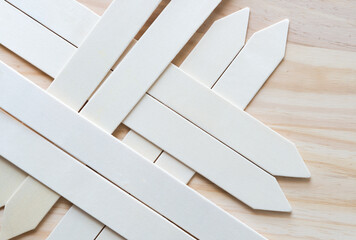 garden spikes or wood sticks with arrow tip on a wooden surface