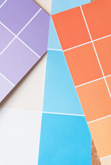 purple, beige, blue, and orange paper pad sheets with paint chip element - macro lens, particular focus