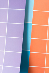 purple, blue, and orange paper pad with paint chip element - macro lens, particular focus