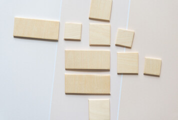 square and rectangle wooden shape cutouts on beige paper pad with paint chip element - macro lens, particular focus