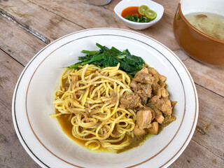 Noodle chicken soup (mie ayam) Indonesia food served on bowl.