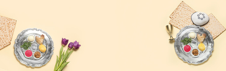 Banner with Passover Seder plates, flatbread matza and flowers on beige background