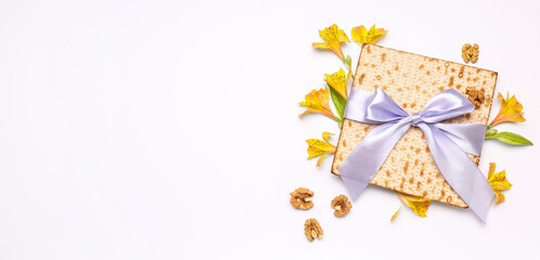 Jewish flatbread matza for Passover and flowers on white background with space for text