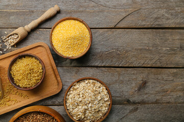 Composition with bowls of different cereals on wooden background