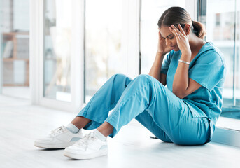 Depression, headache and medical with nurse on floor of hospital for sad, mental health and...