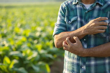 Injuries or Illnesses that can happen to farmers while working. Man is using his hand to scratching over his arm, Itchy pain or feeling ill.