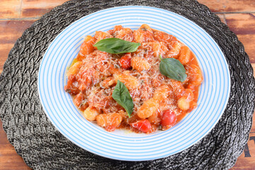 rondelli cannelloni delicious gnocchi pasta in tomato sauce with parmesan cheese, tomatoes, basil, herbs, healthy food of Italian and French cuisine