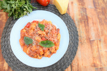 rondelli cannelloni delicious gnocchi pasta in tomato sauce with parmesan cheese, tomatoes, basil, herbs, healthy food of Italian and French cuisine