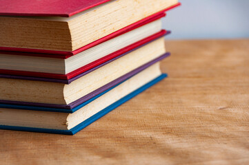 Stacks of books on wooden table with customizable space for text. Copy space and education concept.