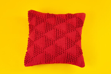 Red decorative pillow on yellow background