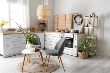 Interior of kitchen with Easter decor, white counters and table