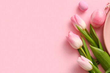 Beautiful tulip flowers and painted Easter eggs on pink background