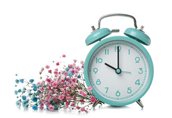 Alarm clock with beautiful gypsophila flowers on white background