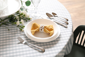 Setting for International Women's Day celebration with cutlery and napkin on table