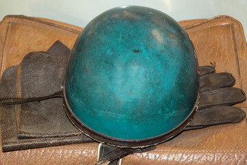 Old motorcycle helmet with gloves