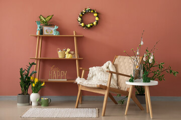 Interior of living room with Easter wreath, shelving unit and armchair