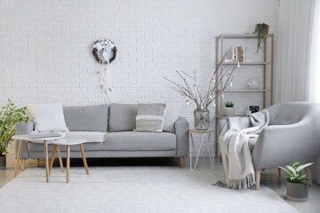 Interior of living room with Easter wreath and sofa