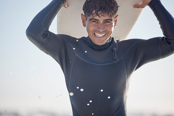 Portrait, vacation and man holding surfboard at the beach, sea or ocean with a smile and is happy...