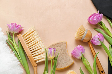 Cleaning brushes with sponge and tulips on beige background. Hello spring
