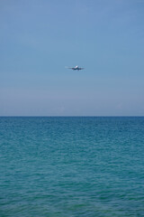 Fototapeta na wymiar big comercial plane landing at Mai Khao Beach airport in Phuket, Thailand.