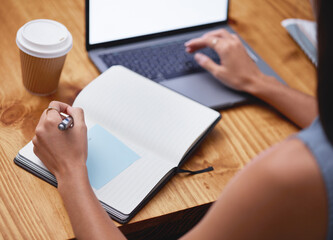 Hands, woman and writing in notebook at desk with laptop, business schedule and office...