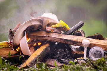 pile of wood and garbage burning on the ground. campfire photography
