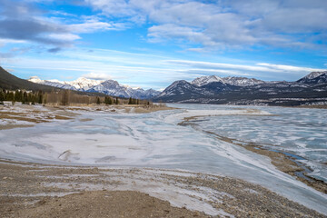 Fototapeta na wymiar Abraham lake landscape in winter season with wave of snow on bluish ice