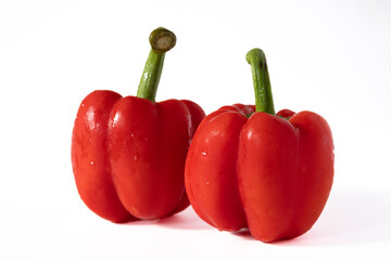 Red sweet bell pepper with water drops isolated on white background..