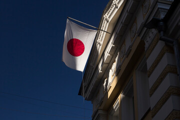 Japanese flag hanging on a flagpole. Japan national flag. 日本の国旗. Close up. Bottom up view.