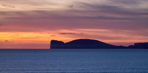 Rocky Coast by the Sea. Sardinia, Italy. Nature Background. Cloudy Sunset Sky. Panorama