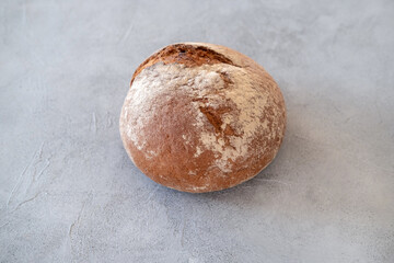 Freshly baked bread loaves on concrete background.