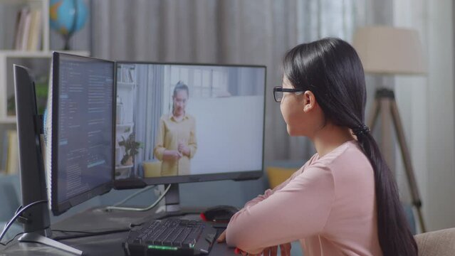 Asian Teen Girl Programmer Learning Online From Teacher On Desktop Computer While Creating Software Engineer Developing App, Program, Video Game At Home. Terminal With Coding Language 
