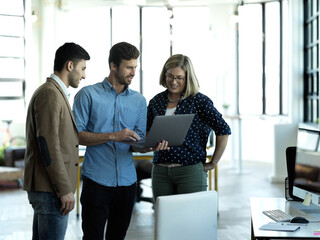 Team, laptop and discussion in workplace, online reading and share ideas for startup, new project...