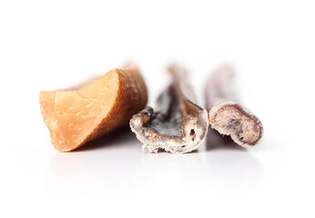 Assortment of dog chew sticks. Close up of yak milk bone, beef bully stick and beef check stick for strong chewer. Natural behavioral enrichment for dogs and dental and mental health. Selective focus.