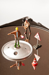 miniature workers on an hard disk