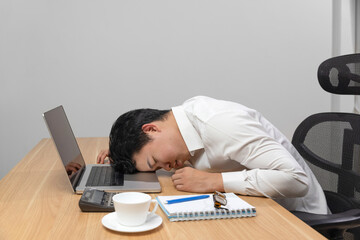 Man with narcolepsy is fall asleep on office desk..Narcolepsy is a sleep disorder that makes people very drowsy during the day.  - obrazy, fototapety, plakaty
