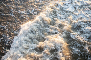 sea waves crashing on a pebbly shore On the Sunset