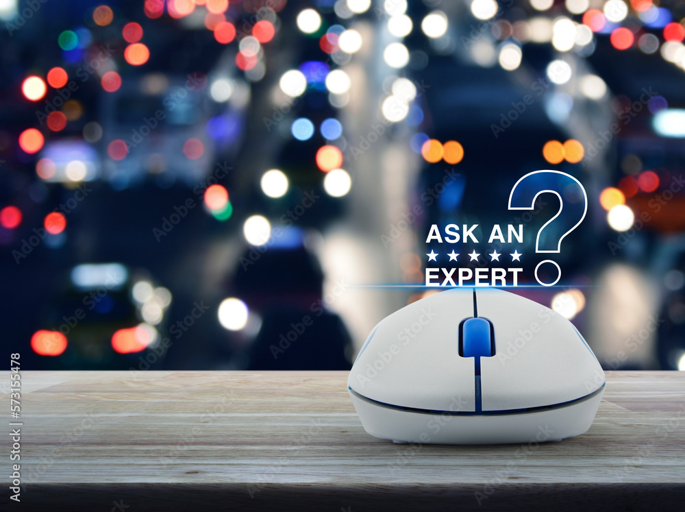 Poster ask an expert with stars and question mark sign icon with wireless computer mouse on wooden table ov