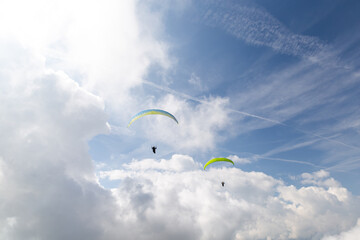 2 paraglides on the cloudy sky