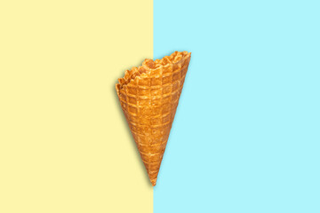 Ice cream cone on a green-yellow pastel background. Summer holiday concept. Food.