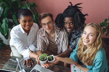 International group of diverse multiracial students working on the biological project, creating new species of plants and flowers. Ecological environmental university college study, experiment, test