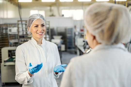 A Supervisor Talking To An Employee In A Food Factory.