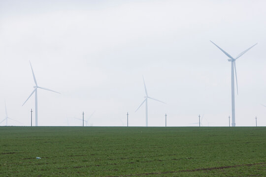 A green field and the wind turbines from Europe's largest wind farm, the F&Atilde;&cent;nt&Atilde;&cent;nele-Cogealac in the Constanta County in Romania.