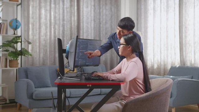 Asian Teen Girl Students Studying Software Code From Brother
