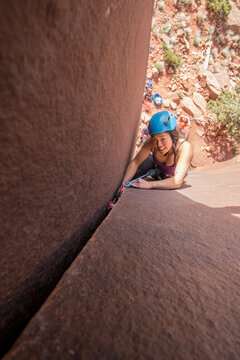 High angle view of woman climbing rock, Utah, USA