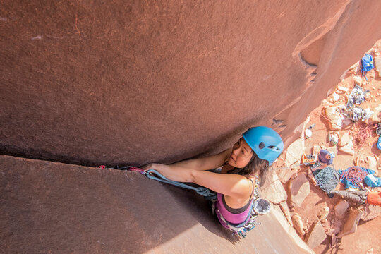 High angle view of woman climbing rock, Utah, USA